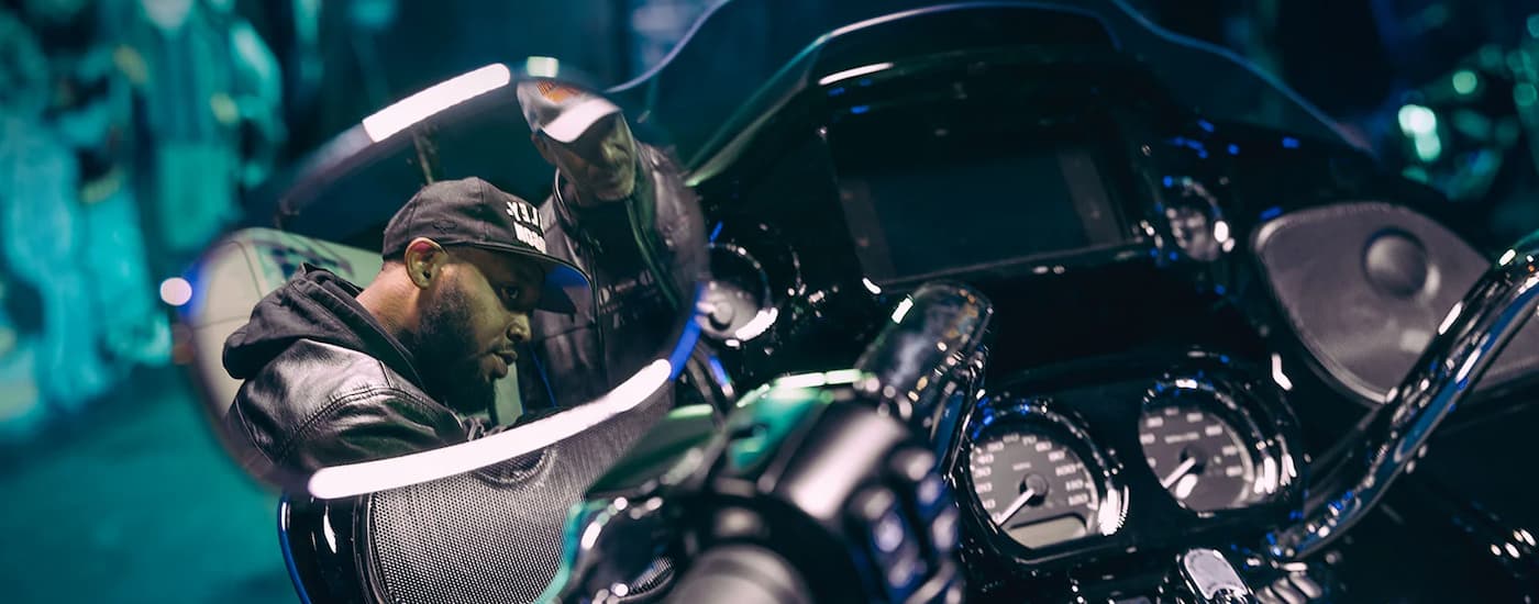 A man is shown in the mirror of a 2023 Harley-Davidson Road Glide 3.