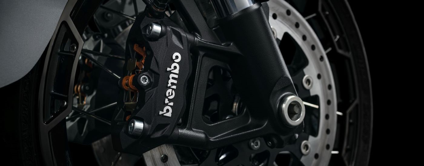 A close up shows the black Brembo caliper on a silver 2023 Harley-Davidson CVO Street Glide.