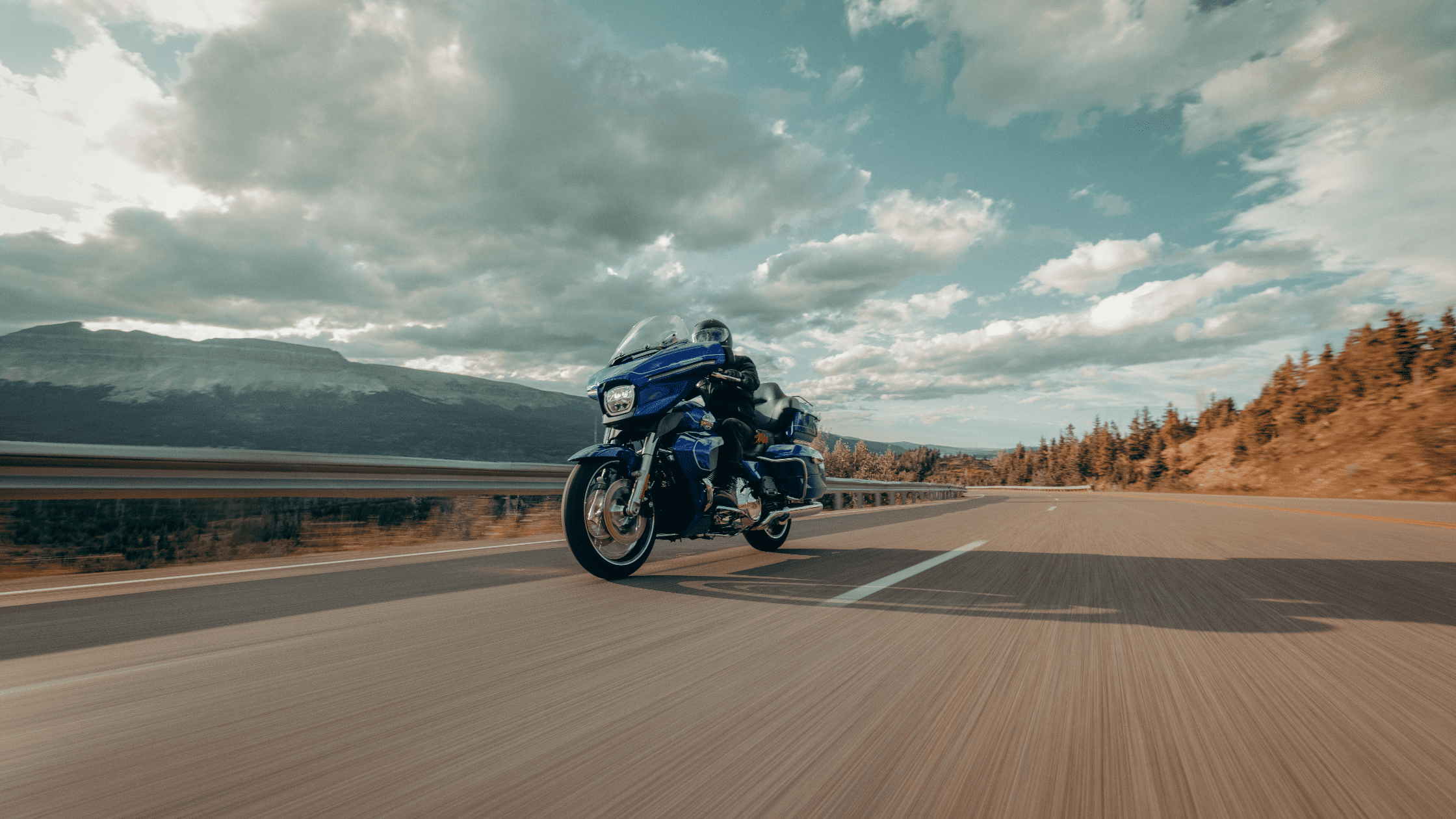 "Rider glides down an open highway on the 2025 Harley-Davidson® Street Glide® Ultra, built for comfo…
