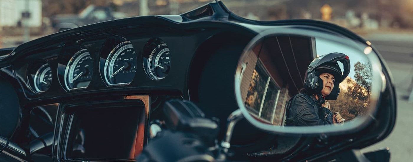 A close up shows the mirror and gauges on a siler 2022 Harley-Davidson Street Glide.