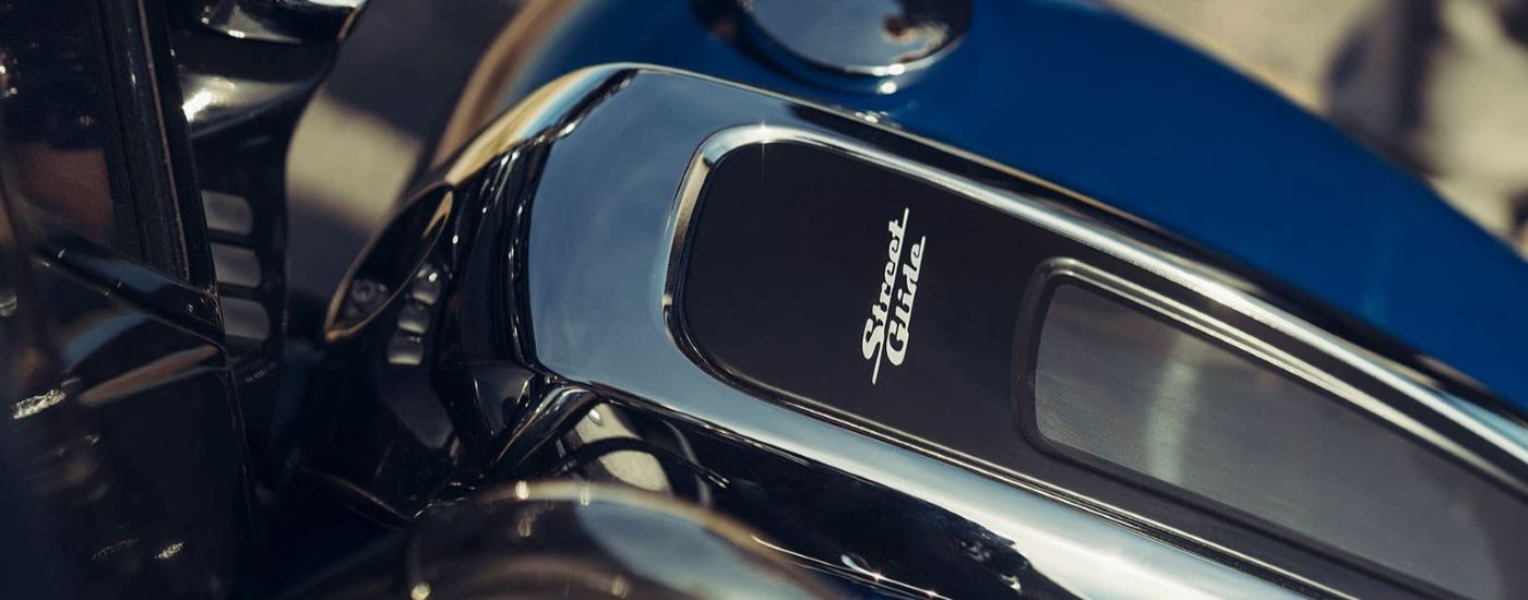 A close up shows the Street Glide badge on a dark blue 2022 Harley-Davidson Street Glide Special.