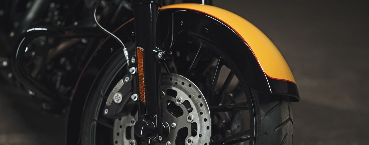 A close up shows the wheel on a yellow 2022 Harley-Davidson Street Glide Special.