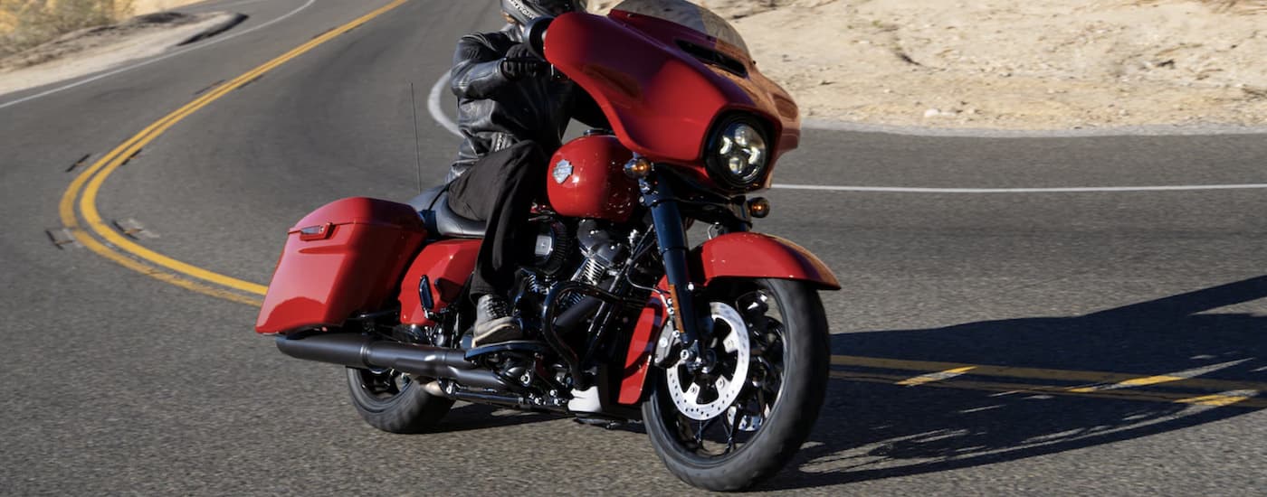 A red 2022 Harley-Davidson Street Glide Special is shown rounding a corner.