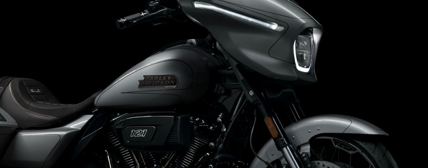 A close up shows the side of a silver 2023 Harley-Davidson CVO Street Glide.