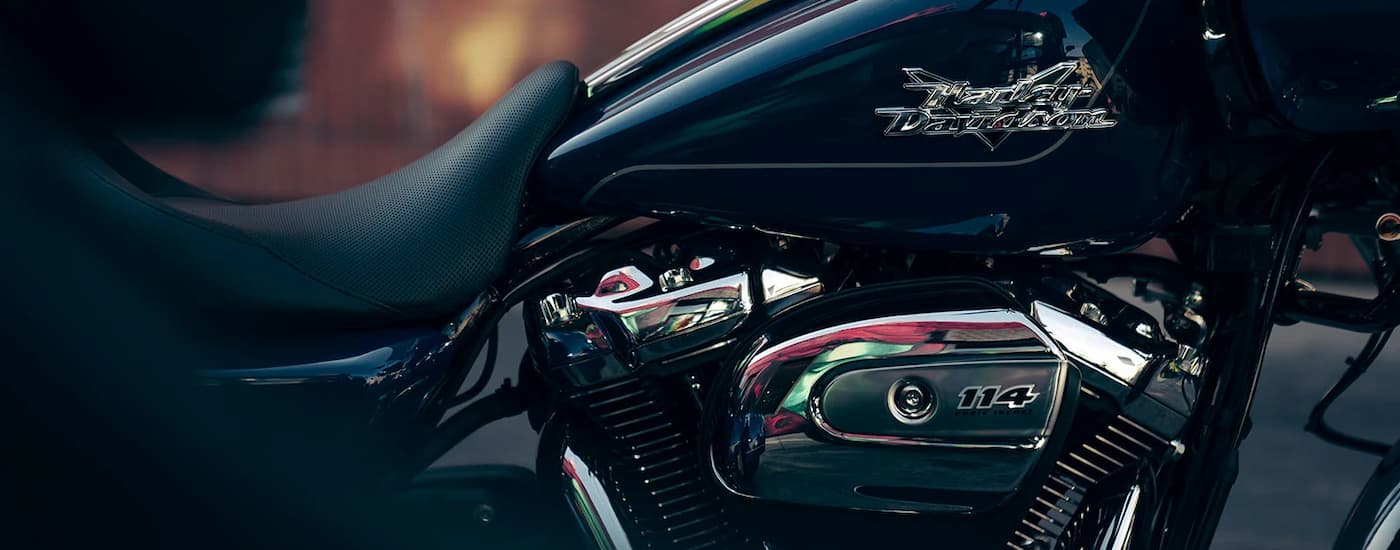 A close up of the side and engine of a 2023 Harley-Davidson Road Glide 3 is shown at night.