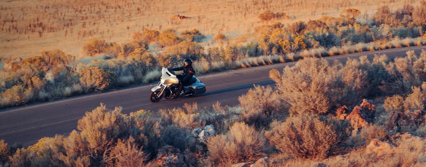 A grey 2023 Harley-Davidson Street Glide is shown riding on an open road from a high angle.