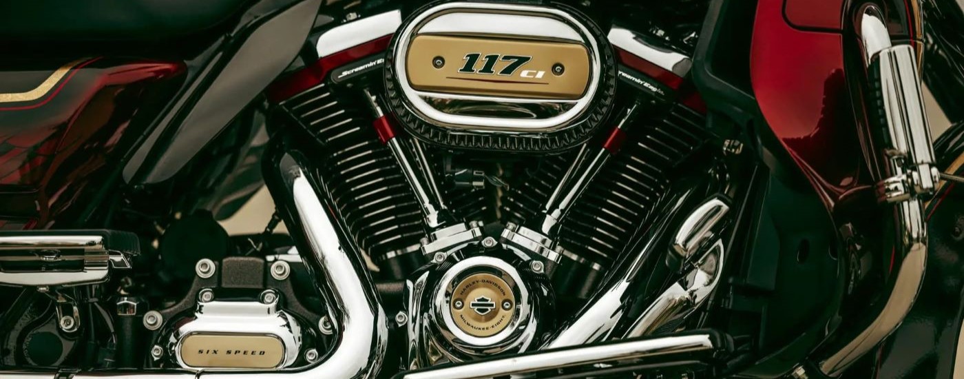 A close up shows the engine on a red and black 2021 Harley-Davidson CVO Road Glide Limited.