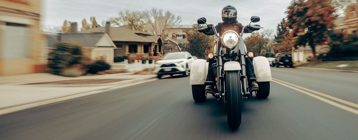 A white 2021 Harley-Davidson Freewheeler is shown from the front on a city street.