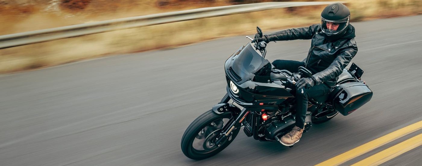 A black 2023 Harley-Davidson Low Rider ST is shown from a high angle on an open road after …