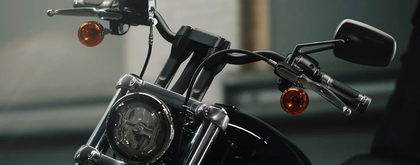 A close up of the front of a black 2024 Harley-Davidson Softail Standard is shown at a …
