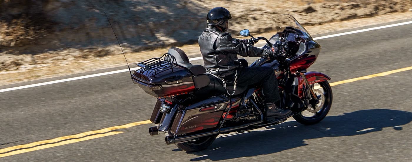 A red 2022 Harley-Davidson CVO Road Glide Limited is shown from the side after leaving a Houston …