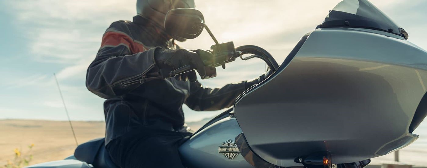 A person is shown riding a silver 2023 Harley-Davidson Road Glide Special.
