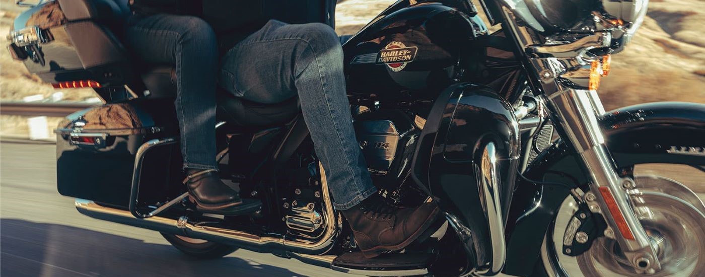 A close up shows people riding on a 2023 Harley-Davidson Ultra Limited.