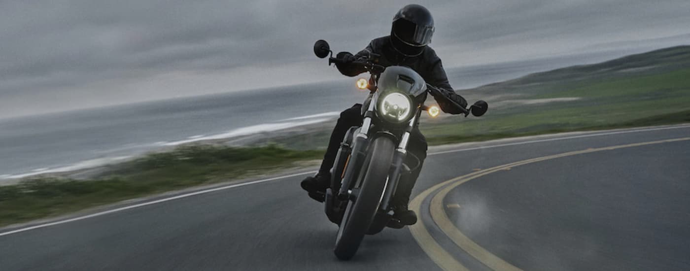 A person is shown front he front riding a black 2022 Harley-Davidson Nightster after leaving a …