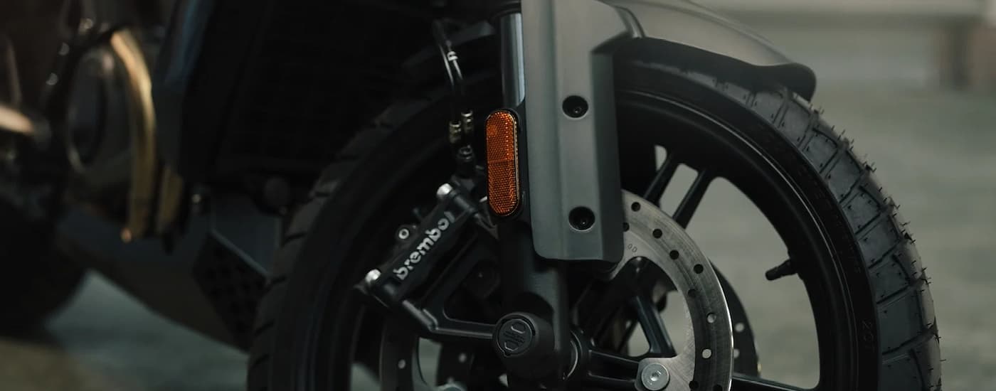 A close up of the front wheel on a 2022 Harley-Davidson Pan America 1250 is shown.